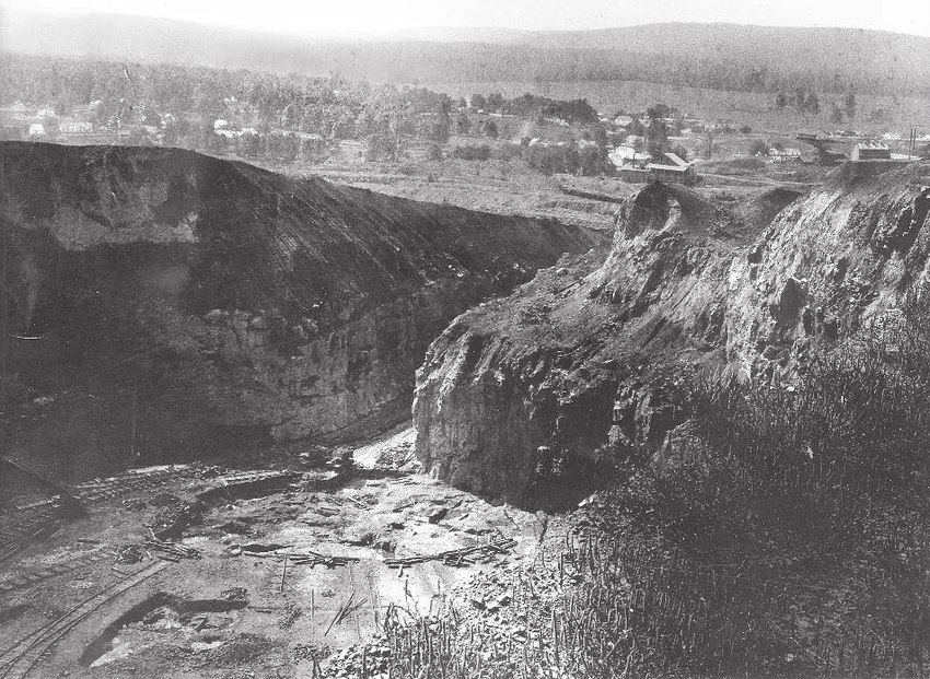 The Big Cut at Iron Mountain standing abandoned in the early 1900s, its quarried faces bare and the floor of the cut empty.