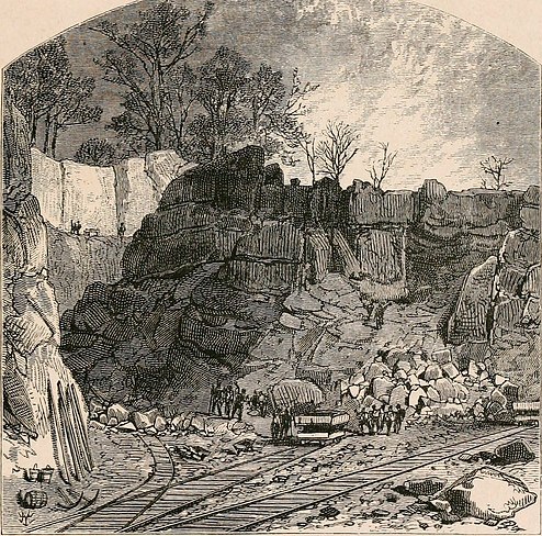 A nineteenth-century wood engraving of the open cut at Iron Mountain: high quarried rock faces, scattered boulders, workers with ore carts, and rail tracks running through the foreground.